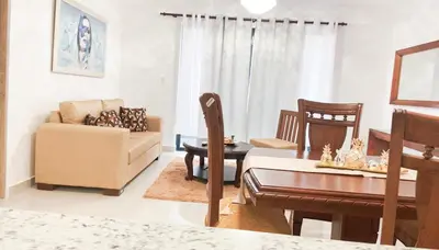 a living room with a couch and a dining room at Livera park in Santiago de los Caballeros