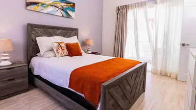 a bedroom with a large bed and a window at Maple Beach Residences Punta Cana in Punta Cana