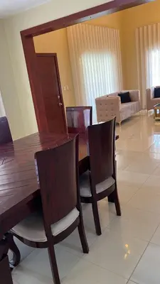 a wooden dining room table and chairs in a living room at Villa La Perla in Pimentel