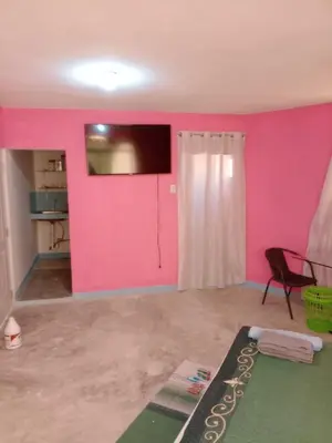 a room with a pink wall and a door at Carvajal in El Higo
