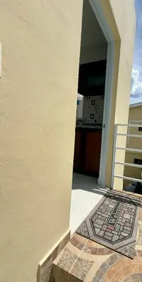 an open door of a house with a mosaic floor at Apartamento acogedor con cocina y balcón privado in Bayahibe