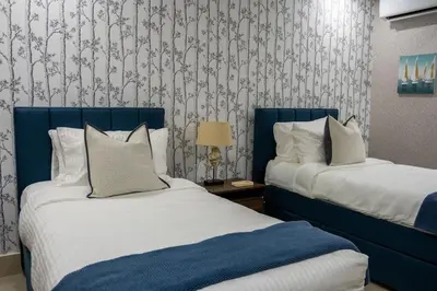 a bedroom with two beds and a wallpaper at Beach Pool Jacuzzi Wifi Netflix Gym 5 Guests in Villas del Mar