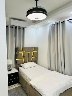 a bedroom with a bed with curtains and a lamp at Apartamento en la romana residencial los García I in La Romana