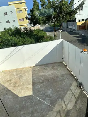 a white retaining wall next to a white fence at Apartamento en la romana residencial los García I in La Romana