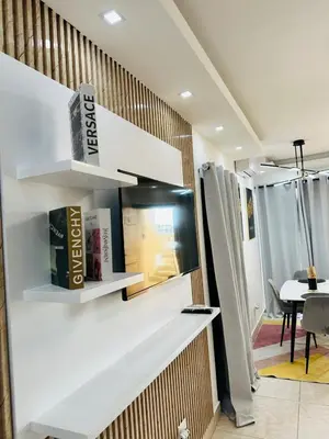 a room with white shelves on a wall with a table at Apartamento en la romana residencial los García I in La Romana