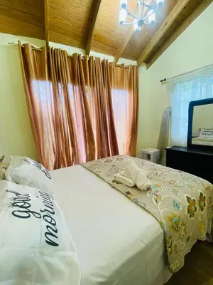 a bedroom with a bed and a television in it at Paris London hause in Los Grini