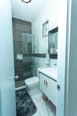 a bathroom with a toilet and a sink and a shower at Ventura Living in Nagua