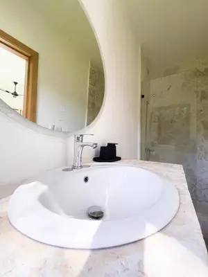 a white sink in a bathroom with a mirror at Jungle Tiny House in El Valle