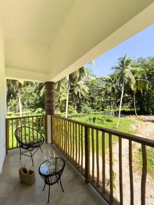 a balcony with two chairs and a table at Jungle Tiny House in El Valle