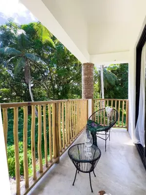 a porch with two chairs and a table at Jungle Tiny House in El Valle