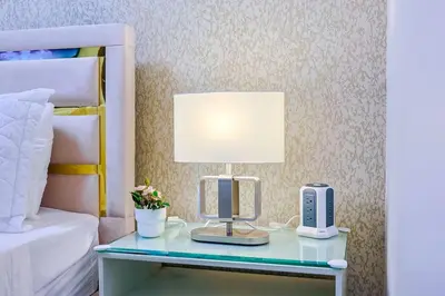 a bedroom with a desk with a computer and a lamp at Cozy 2BR Condo, Spectacular Rooftop in Santo Domingo