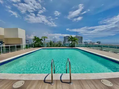 a swimming pool on the roof of a building at Comfy 2BR Condo, Roof Top Pool. in Santo Domingo