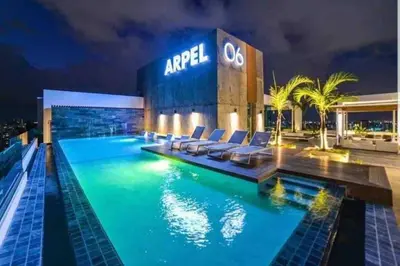 a hotel with a swimming pool at night at Elegant City-Center Luxury Apt in Santo Domingo