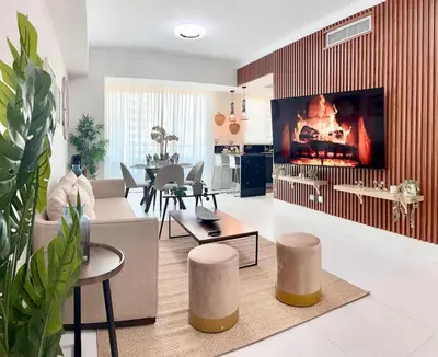a living room with a couch and a fireplace at Elegant City-Center Luxury Apt in Santo Domingo
