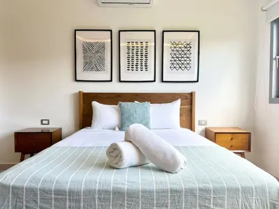 a bedroom with a bed with a stuffed animal on it at Modern 2BD With Pool And Huge Private Terrace in Las Terrenas