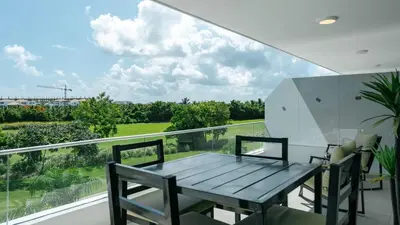 a dining room with a table and chairs on a balcony at Caribbean Heaven in Punta Cana