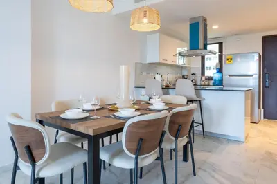 a kitchen and dining room with a wooden table and chairs at Caribbean Heaven in Punta Cana