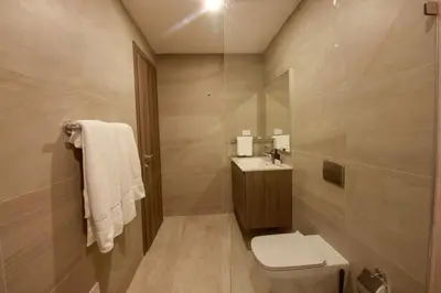 a bathroom with a toilet and a sink and a shower at New Apartment! Beach getaway at Hard Rock in Punta Cana