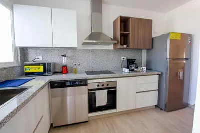 a kitchen with a stainless steel refrigerator and cabinets at New Apartment! Beach getaway at Hard Rock in Punta Cana