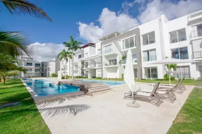 a large white building with a swimming pool in front of it at New Apartment! Beach getaway at Hard Rock in Punta Cana