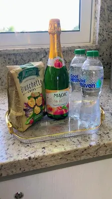 a counter top with two bottles of soda and water at New Apartment! Beach getaway at Hard Rock in Punta Cana