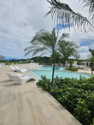 a resort with a swimming pool and a palm tree at Mireyas Sweet Escape with private Jacuzzi in Las Terrenas