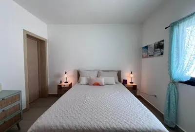 a bedroom with a large bed with two lamps on tables at Mireyas Sweet Escape with private Jacuzzi in Las Terrenas