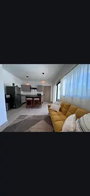 a living room with a couch and a table at Mireyas Sweet Escape with private Jacuzzi in Las Terrenas