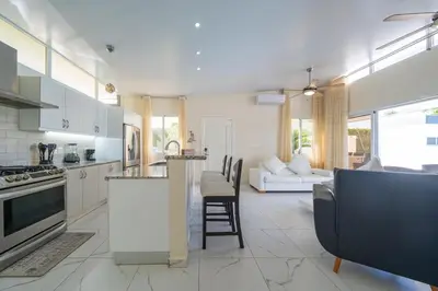 a kitchen and living room with a couch and a table at AC in Living Room, Infinity, Pool Luxury in Sosúa