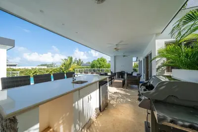 an outdoor kitchen with a view of the ocean at AC in Living Room, Infinity, Pool Luxury in Sosúa