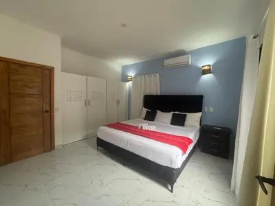 a bedroom with a large bed with a blue wall at Villa Palacio Verde in Las Terrenas