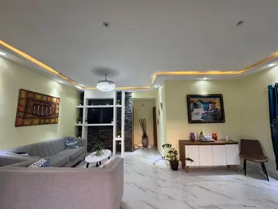 a living room with a couch and a table at Villa Palacio Verde in Las Terrenas