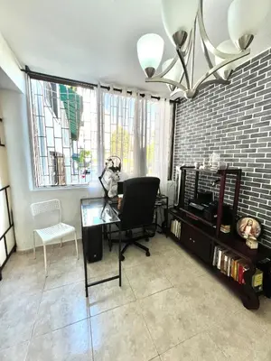 a living room with a glass table and a chair at Alojamiento cerca de Agora y Blue Mall y Cine etc in Santo Domingo