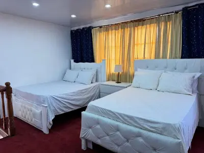 a bedroom with two beds and a window at La placita in Santa Bárbara de Samaná