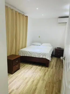 a bedroom with a bed and a wooden floor at La placita in Santa Bárbara de Samaná