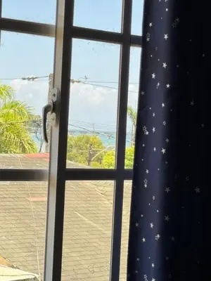 a window with a curtain with stars on it at La placita in Santa Bárbara de Samaná