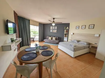 a living room with a bed and a table and chairs at Apartamento frente al mar en Albatros in Villas del Mar