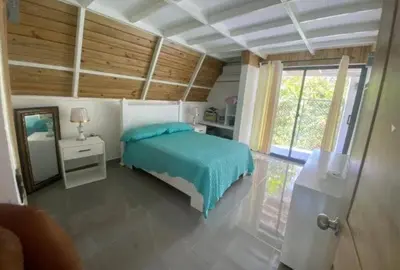 a bedroom with a blue bed and a window at Villa Machepa