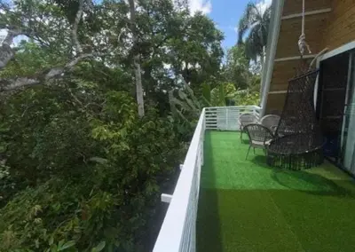 a porch with chairs and grass on a house at Villa Machepa