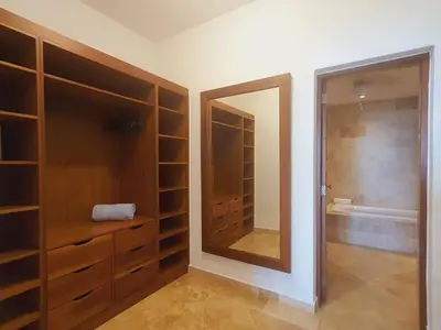 a bathroom with a mirror and a walk in closet at Cabarete Beach Palace 3-BDR Condo in Cabarete