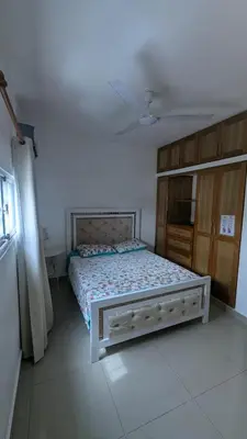 a bedroom with a large bed in a room at Mitaly apartamentos RD H in Santo Domingo