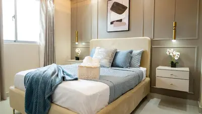 a bedroom with a bed with blue pillows at Luxurious PH, Near Airport,Private Jacuzzi in Santiago de los Caballeros