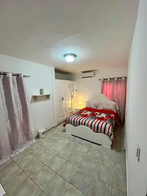a bedroom with a bed with a red curtain at Apartamento in Boca Chica