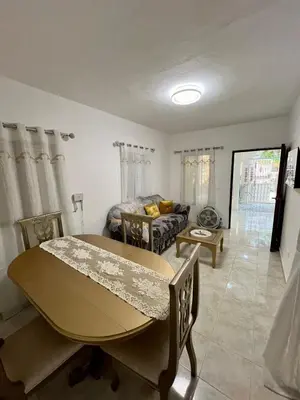 a living room with a table and a couch at Apartamento in Boca Chica