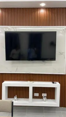 a flat screen tv on a wooden wall at Villa macao in Punta Cana
