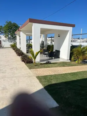 a shadow of a person standing in front of a house at Villa macao in Punta Cana