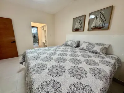 a bedroom with a bed and two pictures on the wall at Your ideal escape in Puerto Plata Beach and fun in San Felipe de Puerto Plata