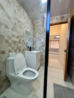 a bathroom with a white toilet in a room at Your ideal escape in Puerto Plata Beach and fun in San Felipe de Puerto Plata