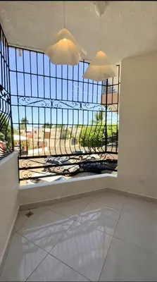 a room with a large window with a view at Your ideal escape in Puerto Plata Beach and fun in San Felipe de Puerto Plata