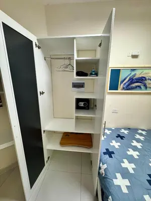 a small bedroom with a bed and white walls at Affordable room near the beach in San Felipe de Puerto Plata